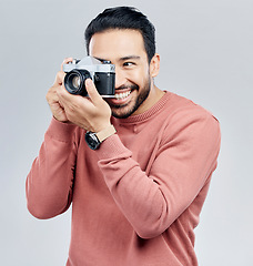 Image showing Man with camera, photography and happy with smile, taking picture with art isolated on studio background. Photographer, happiness and creativity with vintage technology with creative male artist