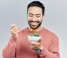 Image showing Man, salad food and eating healthy in studio for health or wellness motivation for vegetables. Asian male happy with vegetable for nutrition, diet and benefits to lose weight on a white background