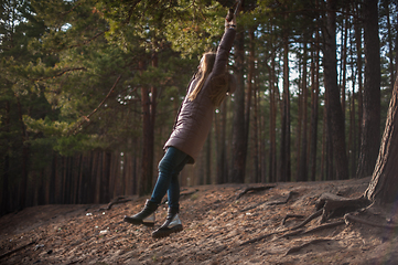 Image showing Woman at bungee in autumn forest