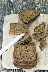 Image showing bread sliced on wooden cutting Board