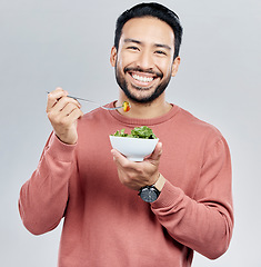 Image showing Man, salad and eating healthy portrait in studio for wellness food motivation with vegetables. Asian male smile for vegetable nutrition, diet and benefit for digestion or lose weight white background