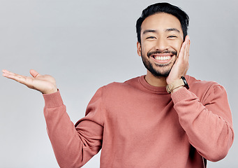 Image showing Space, happy and a portrait of Asian man showing mockup isolated on a white background. Excited, promotion and guy gesturing for branding, advertising and marketing in studio with mock up backdrop