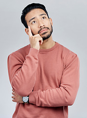 Image showing Thinking, confused and question with a man in studio on a gray background looking thoughtful or contemplative. Doubt, idea and memory with a young asian male trying to remember but feeling unsure