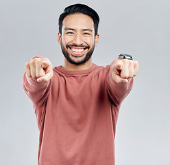 Image showing Pointing, selection and smile with portrait of man in studio for thank you, motivation and amazing. Winner, confident and friendly with male on white background for yes, achievement and satisfaction