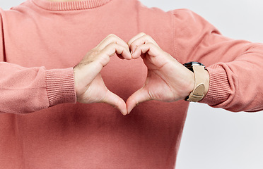 Image showing Heart, man and hands for love in studio to show support, thank you or charity sign language. Male model person with hand icon for kindness, care and hope review, motivation or emoji opinion feedback