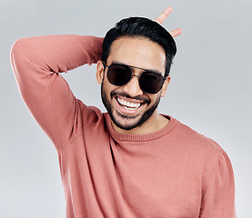 Image showing Cool, funny and funky Asian man with sunglasses isolated on a white background in a studio. Portrait, comic and a laughing stylish Chinese guy with fashionable eyewear and crazy gesture on a backdrop