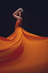 Image showing Fashion, woman and elegant with beauty on dark background, portrait and model in orange dress in studio. Indian female, glamour and stylish ballgown with sexy person, luxury style and designer wear