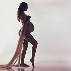 Image showing Woman, pregnant and fabric with silhouette in studio with hands, touch and healthy by white background. Pregnancy model, shadow art or wellness mockup with cloth, body and stomach with dark aesthetic