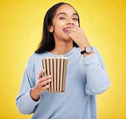 Image showing Happy woman is eating popcorn, watching tv and portrait, box with snack for movie on yellow studio background. Streaming service, film and food with corn treat, female with smile and cinema