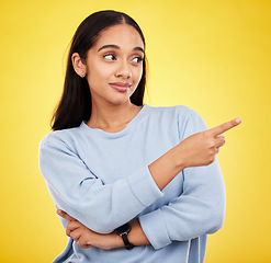 Image showing Yellow background, point and face of woman in studio for advertising, promotion and announcement. Mockup space, news and isolated girl with hand gesture showing information, discount and branding