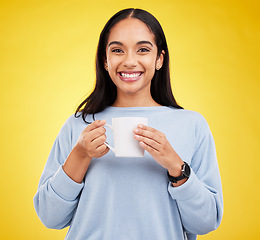 Image showing Smiling portrait, coffee mug and happy woman in a studio with a smile from espresso. Isolated, yellow background and drink of a young female with happiness and joy ready to start the day with tea