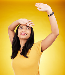 Image showing Freedom, happy and dance with a woman on a yellow background in studio feeling positive or carefree. Energy, fashion and smile with an attractive young gen z female dancing or moving to music