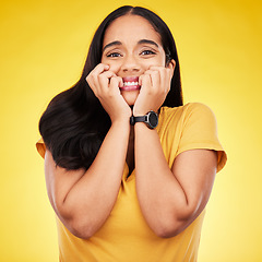 Image showing Nervous, fear portrait and woman in a studio with stress and anxiety with nail biting. Isolated, yellow background and panic of a scared person feeling terror, phobia and mental health problem