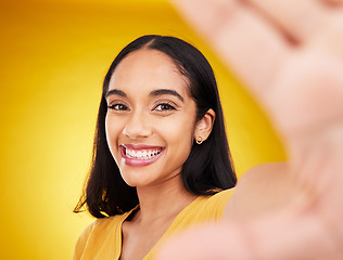 Image showing Happy, smile and selfie with woman in studio for social media, confidence and picture. Photo, happiness and relax with portrait of female on yellow background for beauty, self care and influencer