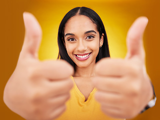 Image showing Thumbs up, portrait and hands of happy woman in studio, excited winner and bonus on background. Female model, thumb and smile to celebrate winning achievement, like emoji and support, yes or feedback