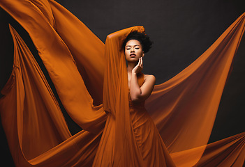 Image showing Black woman, art and fashion, flowing fabric on dark background with beauty and aesthetic movement. Silk, fantasy and artistic portrait of serious African model in creative designer dress in studio.