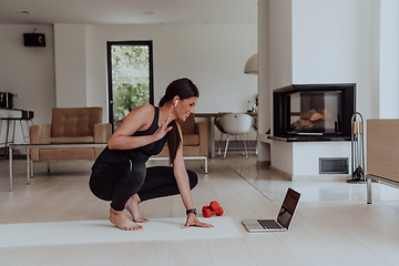 Image showing Young Beautiful Female Woman with Trainer via Video Call Conference in Bright Sunny House. Healthy Lifestyle, Wellbeing and Mindfulness Concept.