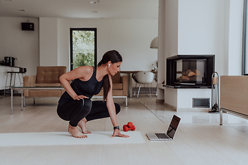 Image showing Young Beautiful Female Woman with Trainer via Video Call Conference in Bright Sunny House. Healthy Lifestyle, Wellbeing and Mindfulness Concept.