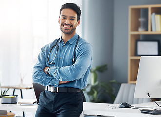 Image showing Portrait, man and doctor with arms crossed in medical office, motivation or trust. Happy male healthcare worker, employee and expert of wellness management, happiness and commitment to pride or smile