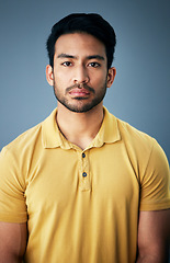 Image showing Confidence, serious and portrait of a man in studio with depression, sadness or mental health problem. Tired, exhausted and Indian male model with burnout face expression isolated by gray background.