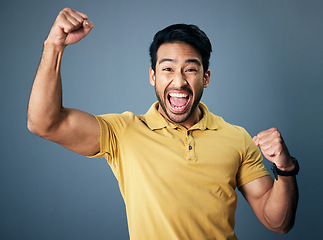 Image showing Indian man, celebration fist and studio portrait for winning mindset, happiness or achievement by background. Young model, male student and celebration with happy, excited face or winning by backdrop