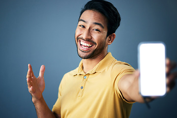 Image showing Phone mockup, studio portrait and happy man with online ui for product placement, branding copy space or marketing. Advertising mock up, white screen cellphone and excited person on blue background