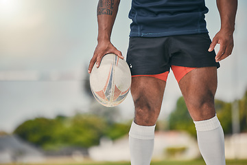 Image showing Rugby, man and ball, zoom on legs of strong, muscular male ready at winning game on field. Fitness, sports and professional sport player at practice match, workout or competition on grass at stadium