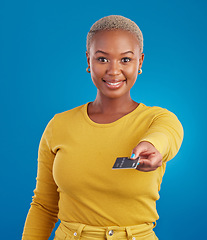 Image showing Credit card, payment portrait and happy woman in a studio with success from paying a bill. Isolated, blue background and ecommerce with a young female model hand showing financial banking method
