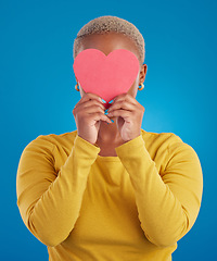 Image showing Paper, heart and hide with black woman in studio for love, date and kindness. Invitation, romance and feelings with female and shape isolated on blue background for emotion, support and affectionate