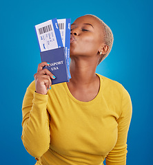 Image showing Kiss, travel passport and black woman in studio on blue background for flight documents, tickets and ID. Traveling mockup, happy and girl celebrate immigration, USA holiday and international vacation