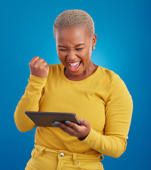 Image showing Success winner woman on tablet isolated on blue background fist pump, yes and cheers for online news. Winning, competition and giveaway prize for african person on digital tech celebration in studio