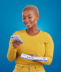 Image showing Travel passport, smartphone and black woman in studio on blue background with flight documents, tickets and ID. Traveling mockup, online booking and girl for immigration, holiday and global vacation