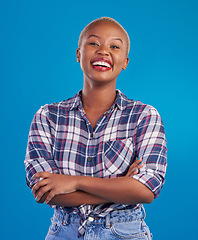 Image showing Smile, crossed arms and portrait of black woman with happy mindset, proud and empowerment in studio. Fashion, beauty and attractive girl on blue background with wellness, happiness and motivation