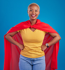 Image showing Black woman, superhero cape and portrait in studio, blue background and fashion. Happy female model, superwoman and brave cosplay character of justice, smile and pride of girl power, proud and strong