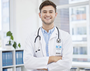 Image showing Smile, doctor and portrait of man in hospital with crossed arms for wellness, medicine and medical care. Healthcare, insurance and happy health worker in clinic for consulting, trust and stethoscope
