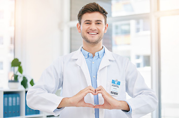 Image showing Hands in heart, doctor and portrait of man in hospital with sign for wellness, medicine and medical care. Healthcare, insurance and happy worker in clinic for consulting, trust and cardiology support