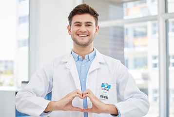 Image showing Healthcare, hands in heart and portrait of doctor in hospital with emoji for wellness, medicine and medical care. Smile, love gesture and happy man in clinic for consulting, insurance and support