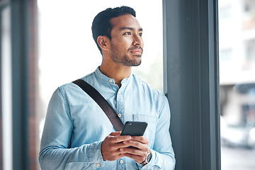 Image showing Phone, thinking and man by office window for career inspiration, job search or online networking. Contemplating asian person or young entrepreneur cellphone, smartphone or mobile app in workplace