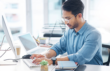 Image showing Serious, business man and typing on computer in office for startup management, planning and agency. Focused male worker at desktop technology for online project, website or internet research at table