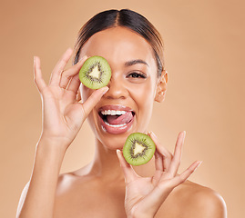 Image showing Skincare, kiwi and portrait of woman with smile in studio for wellness, organic facial and natural cosmetics. Beauty, dermatology spa and happy face girl with fruit for detox, vitamin c and nutrients