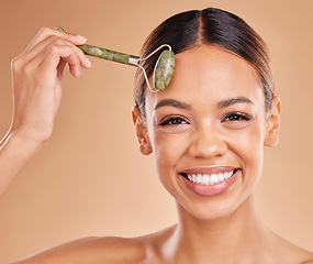 Image showing Happy woman, beauty or face portrait with roller, facial product for healthy skincare on studio background. Big smile, crystal stone treatment or girl model with dermatology cosmetics or massage