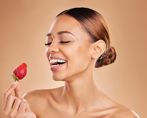 Image showing Beauty, skincare or happy woman with strawberry in studio on beige background for healthy nutrition or clean diet. Smile, face or funny girl model laughing or marketing natural fruits for wellness