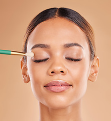 Image showing Makeup brush, portrait or woman face with eyeshadow, facial products or self care beauty on studio background. Model, eyes closed or beautiful girl with eyeliner cosmetics or natural glowing skincare