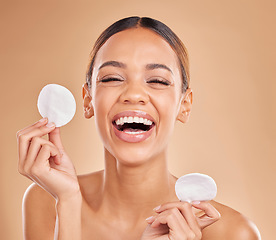 Image showing Face, funny and woman with cotton pad, skincare and happiness against a brown studio background. Portrait female and lady laughing, makeup remover and foundation with smile, dermatology and grooming