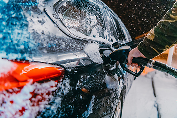 Image showing Refuelling diesel gas on petrol station at winter