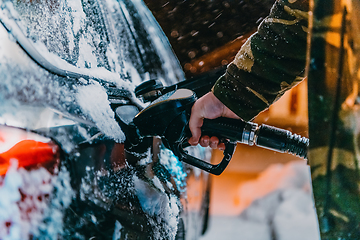 Image showing Refuelling diesel gas on petrol station at winter