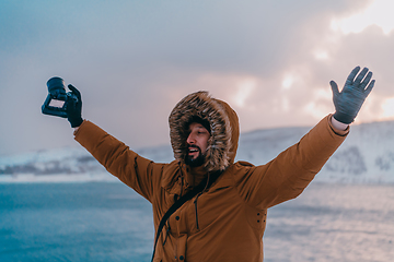 Image showing A photographer in the cold Skavdinava regions tries to take a photo for journalism in a strong winter storm