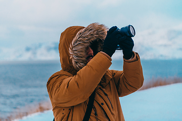 Image showing A photographer in the cold Skavdinava regions tries to take a photo for journalism in a strong winter storm