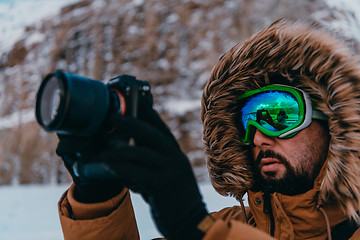 Image showing A photographer in the cold Skavdinava regions tries to take a photo for journalism in a strong winter storm