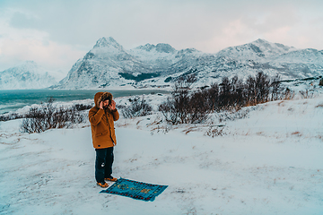 Image showing A Muslim traveling through arctic cold regions while performing the Muslim prayer namaz during breaks